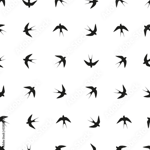 Vector seamless pattern. Black silhouette of a swallow. © Andrii Artamonov