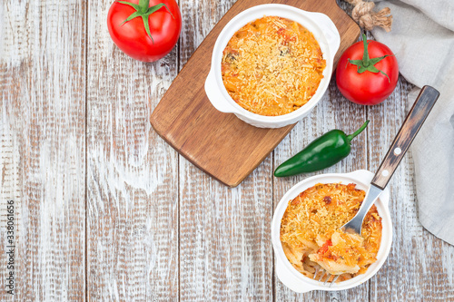 Spicy tomato jalapeno mac and cheese with mini penne pasta, in baking dish, horizontal, copy space, top view