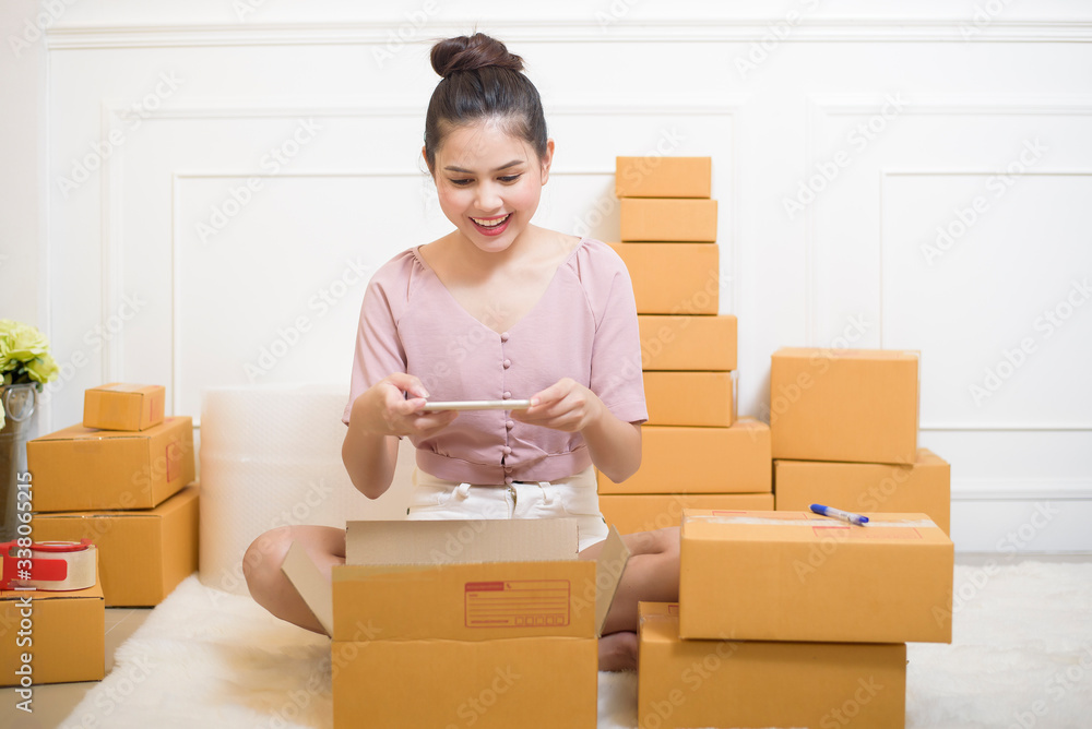 a woman is preparing products with cardboard boxes for shipping. a woman is preparing products with cardboard boxes for shipping.