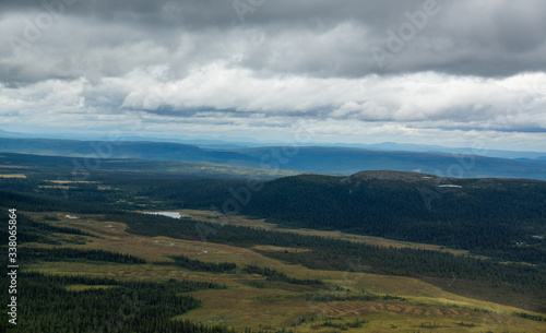 panoramic overview over a valley with forest and lakes in sweden on a cloudy day © stalmphotos