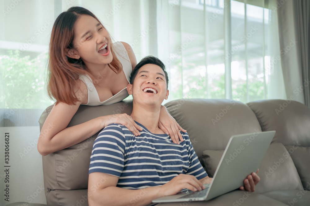 Happy asian couple shopping online using digital tablet with holding credit card and sitting on sofa at home together. Happy lifestyle concept.. Happy asian couple shopping online using digital tablet with holding credit card and sitting on sofa at home together. Happy lifestyle concept..