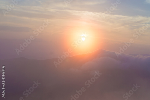 sunset in the mountains, mountains in the clouds in a haze © Serhii  Holdin
