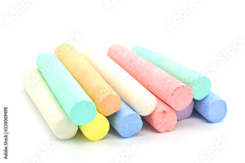 Multi-colored crayons on a white background. Colored chalk. Wallpaper. Art supplies. Children's stationery. The tool of the artist. Materials for creativity. Hobby goods.