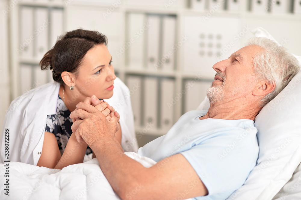 Senior man portrait in hospital with caring daughter Senior man portrait in hospital with caring daughter