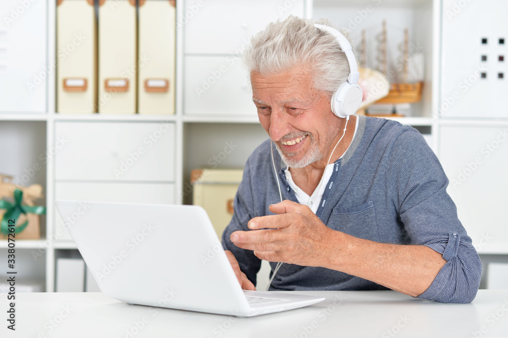 Portrait of confident senior man using laptop Portrait of confident senior man using laptop
