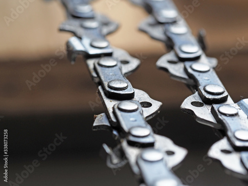 Canvas-taulu metal chainsaw chain with sharp teeth close-up with blurred background