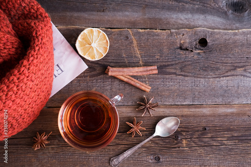 Fototapeta Naklejka Na Ścianę i Meble -  tea with cinnamon and lemon on a wooden background