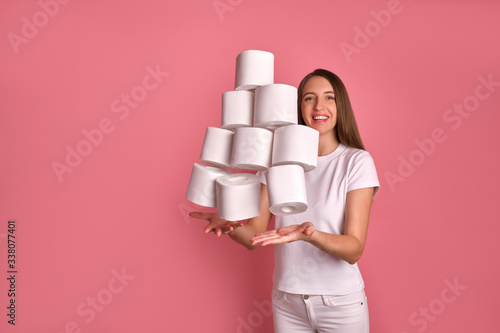 Photos Smiling adult girl in good spirits throwing up toilet paper