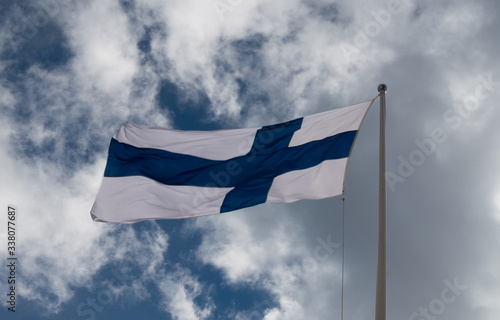 flag of finland against the cloudy sky photo