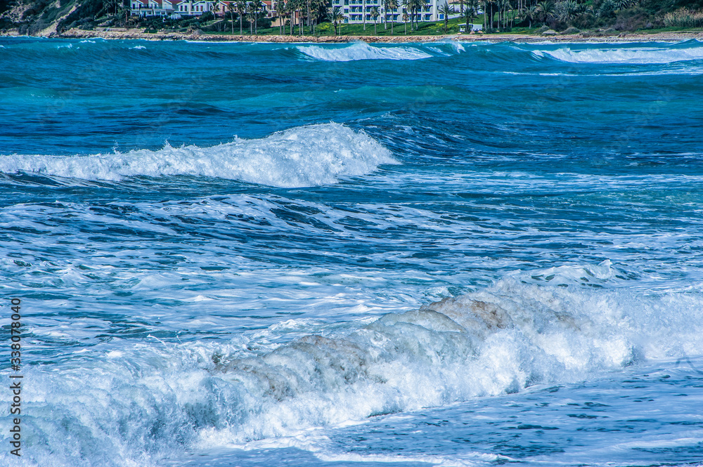 A fresh spring wind drives the waves to the coast of Cyprus. The Mediterranean Sea is painted with dark ultramarine and a luminous azure from the inside. A fresh spring wind drives the waves to the coast of Cyprus. The Mediterranean Sea is painted with dark ultramarine and a luminous azure from the inside.