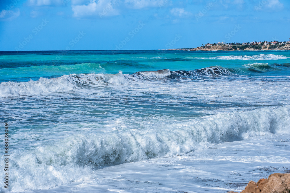 A fresh spring wind drives the waves to the coast of Cyprus. The Mediterranean Sea is painted with dark ultramarine and a luminous azure from the inside.     