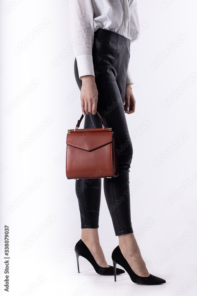 Model girl with leather elegant women bag. Fashionable female handbag, isolated Model girl with leather elegant women bag. Fashionable female handbag, isolated