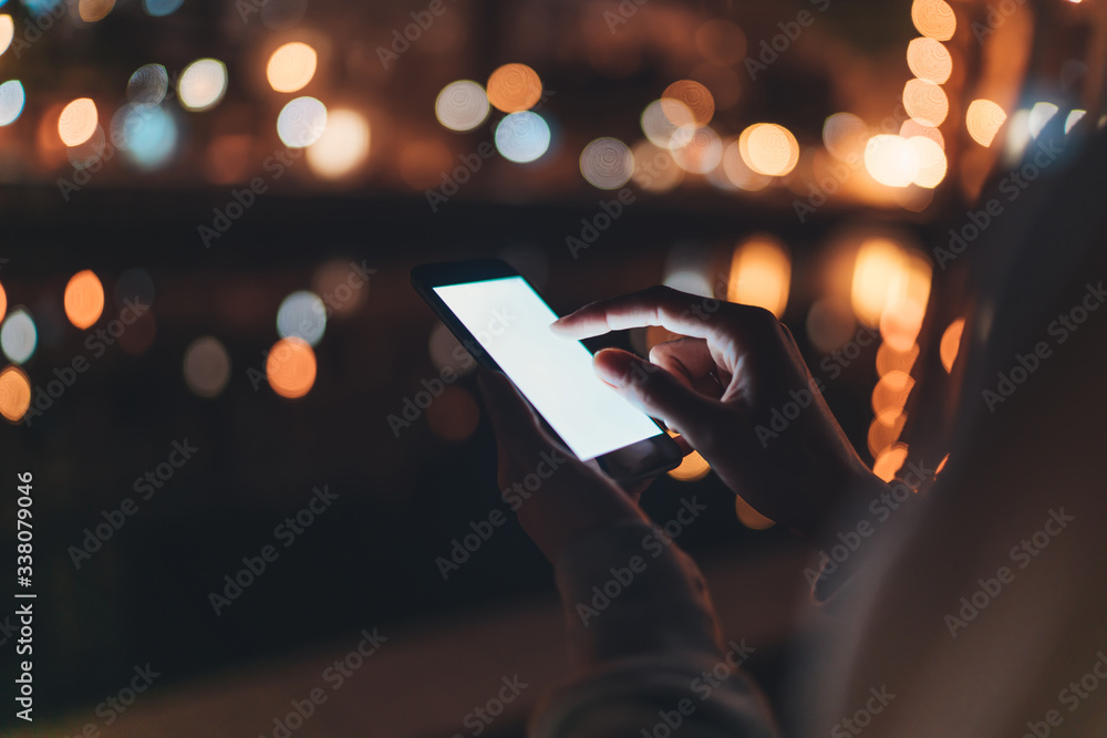 person texting text message on smartphone light night city, hipster touch on template screen, girls using in hands mobile phone closeup, mockup blank screen - obrazy, fototapety, plakaty 