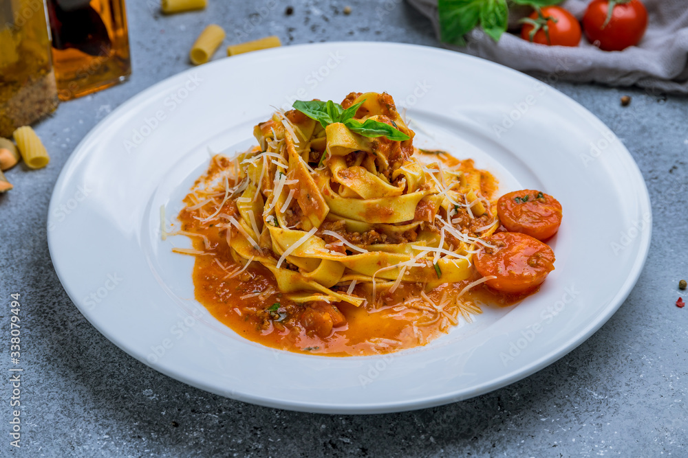 Pasta fettuccine Bolognese on grey table Pasta fettuccine Bolognese on grey table