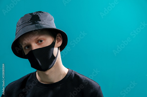 The guy in the black medical mask and bucket hat and black jacket looks