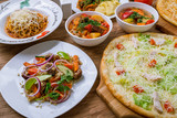 dishes of Uzbek cuisine lagman, pilaf, shurpa and pizza, pasta bologniese.
