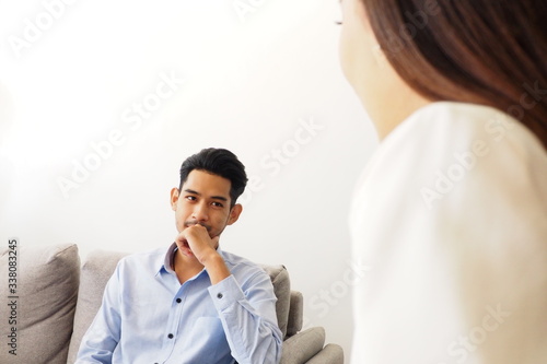 Asian man seeking advice from professional female psychiatrist to diagnose his mental disorder and emotion due to his stress about work and life problems. Psychological consultation and health concept