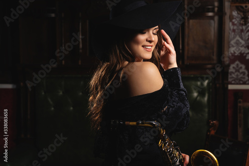 Canvas Print Portrait of a smiling girl in a hat and in a dress with bare shoulders