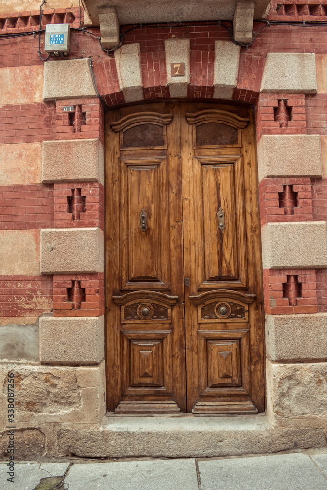Fototapeta premium Old wooden door, brick facade