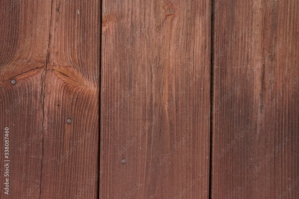 Naklejka premium Old wooden boards nailed with rusty nails.