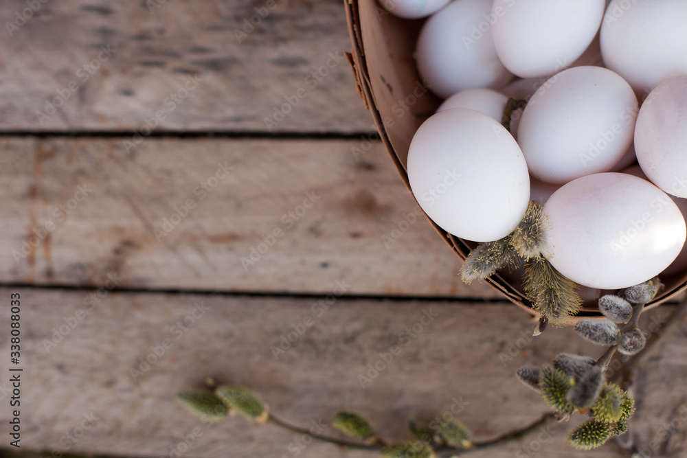 Chicken eggs in   basket on   wooden background