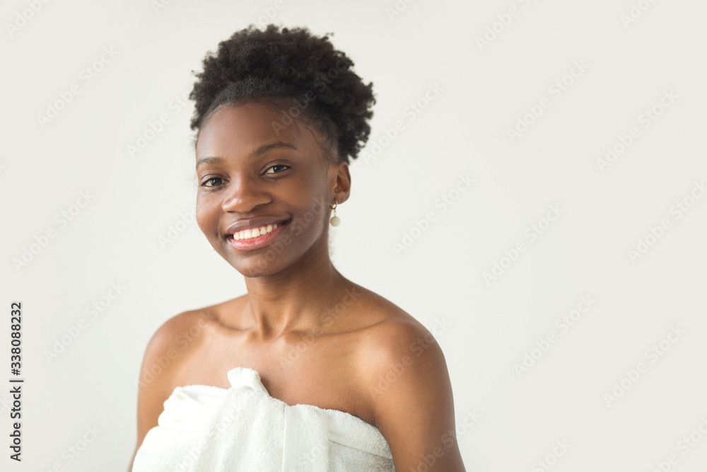beautiful young african woman in towel on white background beautiful young african woman in towel on white background