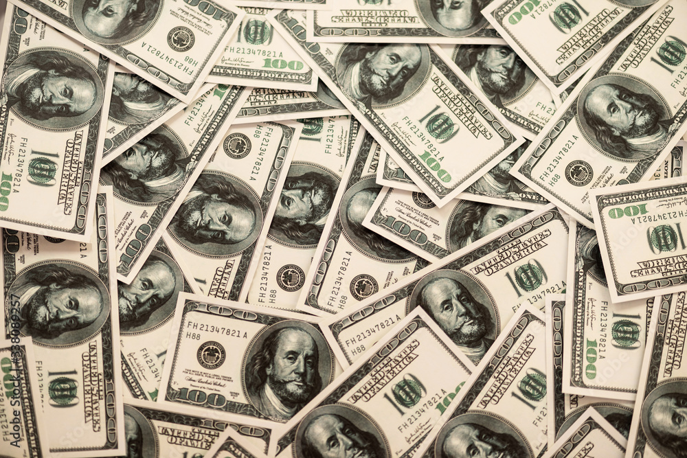 Money on a background with dollars thrown randomly Money on a background with dollars thrown randomly