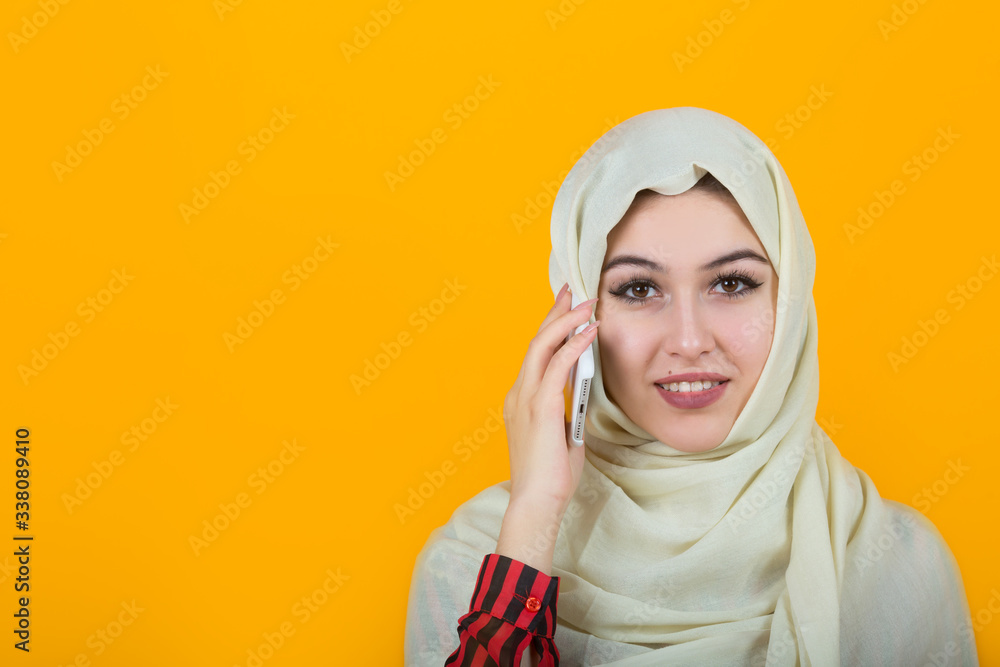 beautiful young woman in muslim shawl on yellow background beautiful young woman in muslim shawl on yellow background