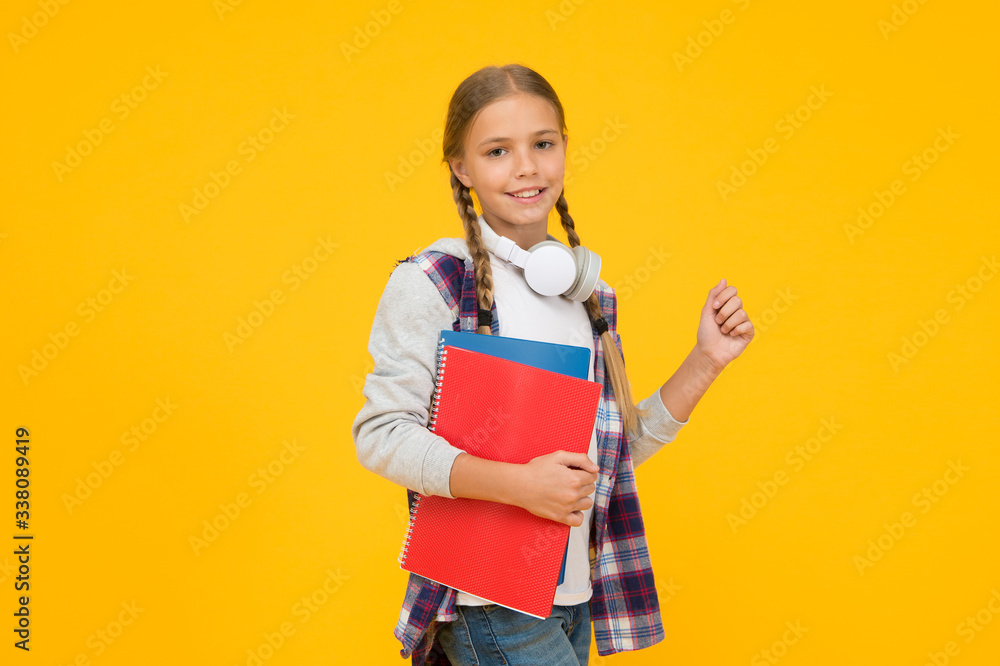 Study lessons for exam. find inspiration in music. Enjoying elearning. modern education concept. little girl in headphones with notepad. back to school. hipster child at school. childhood happiness Study lessons for exam. find inspiration in music. Enjoying elearning. modern education concept. little girl in headphones with notepad. back to school. hipster child at school. childhood happiness