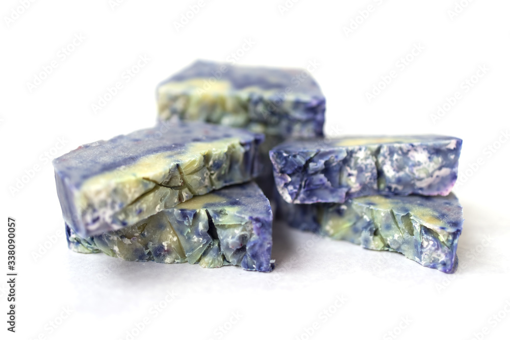 Hand made lavender soaps on the white background. Copy space. Place for text and design. Natural cosmetic. Home business. Voluntary Isolation