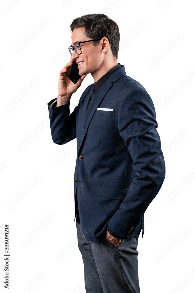 Urban business man talking on smart phone. Formal young businessman wearing suit. Isolated.