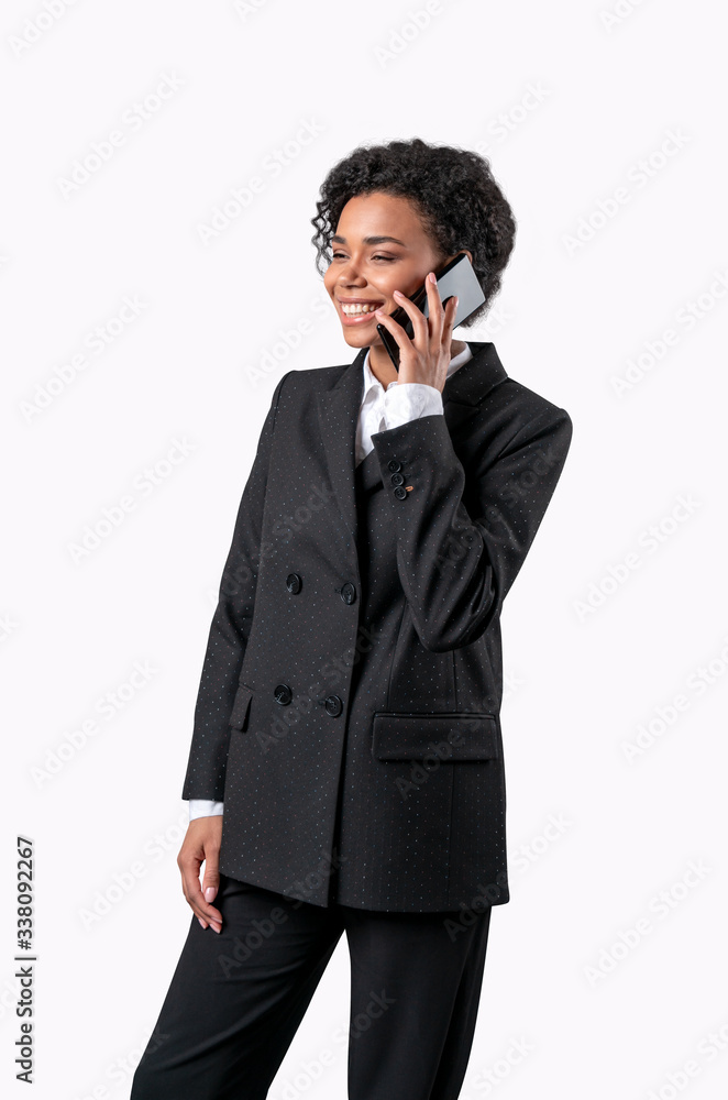 Beautiful happy smiling african american businesswoman talking on the phone. Isolated on white background. Beautiful happy smiling african american businesswoman talking on the phone. Isolated on white background.