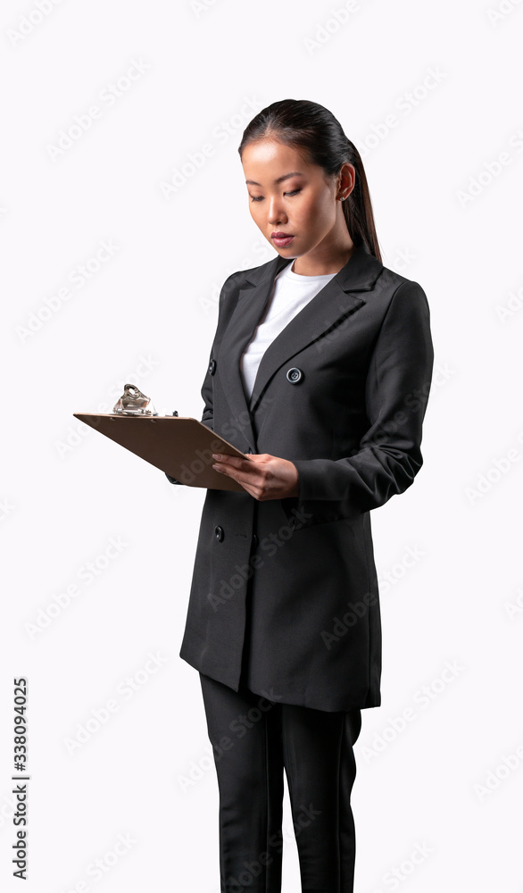 Pretty young asian beautiful woman standing, writing, take notes, holding notebook organizer in hand thinking getting ready for final exam on a white background Pretty young asian beautiful woman standing, writing, take notes, holding notebook organizer in hand thinking getting ready for final exam on a white background