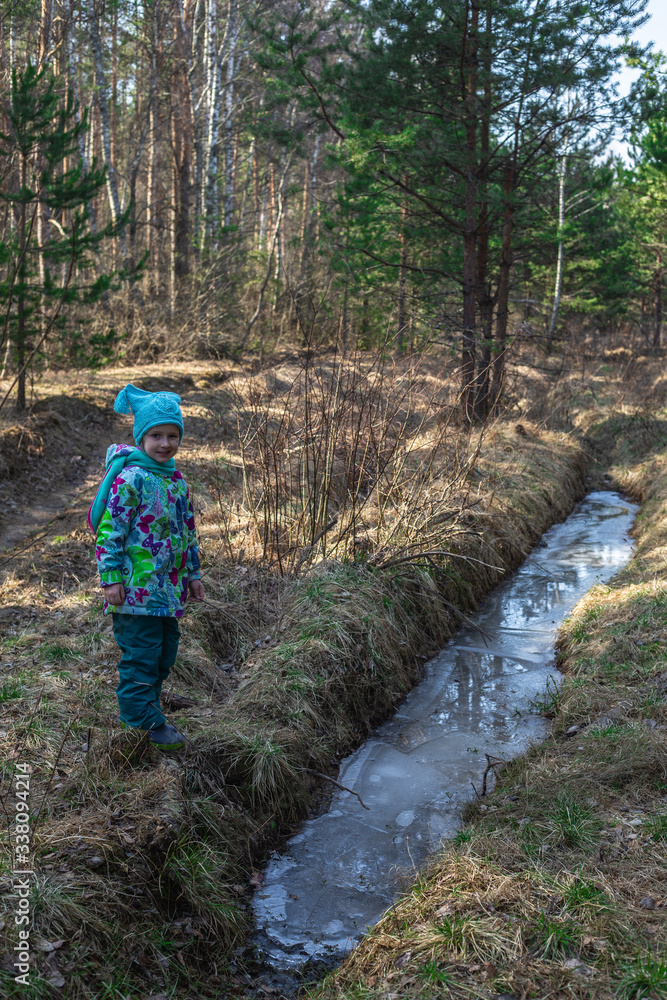 little girl walking in the woods