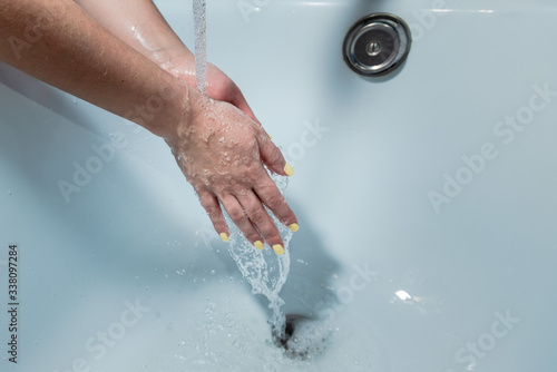 Coronavirus pandemic prevention wash hands with soap warm water