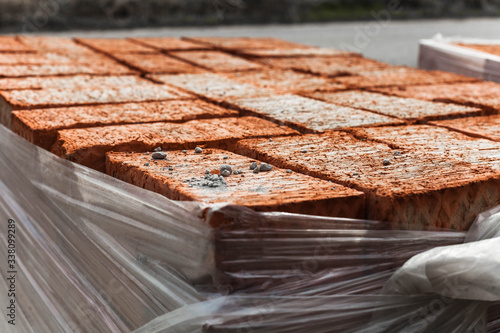 a bunch of red bricks on a pallet