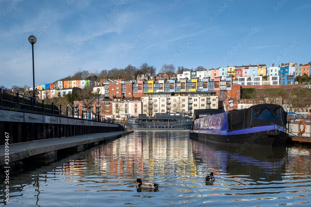 Obraz premium A view across Bristol harbour towards colourful houses in Hotwells and Cliftonwood. 