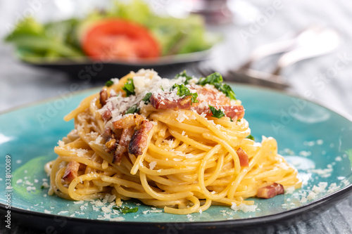 spaghetti carbonara on a blue plate