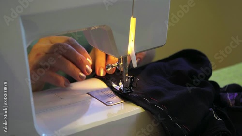 Clothier. Sewing on a typewriter, mending.