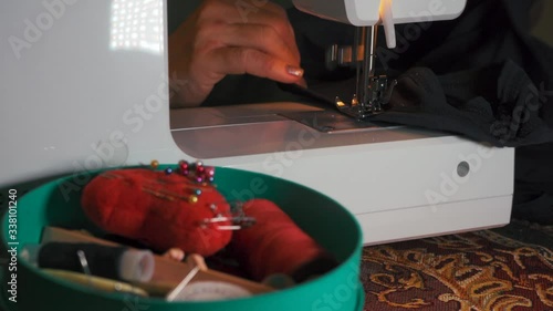 Clothier. Sewing on a typewriter, mending.