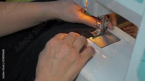 Clothier. Sewing on a typewriter, mending.