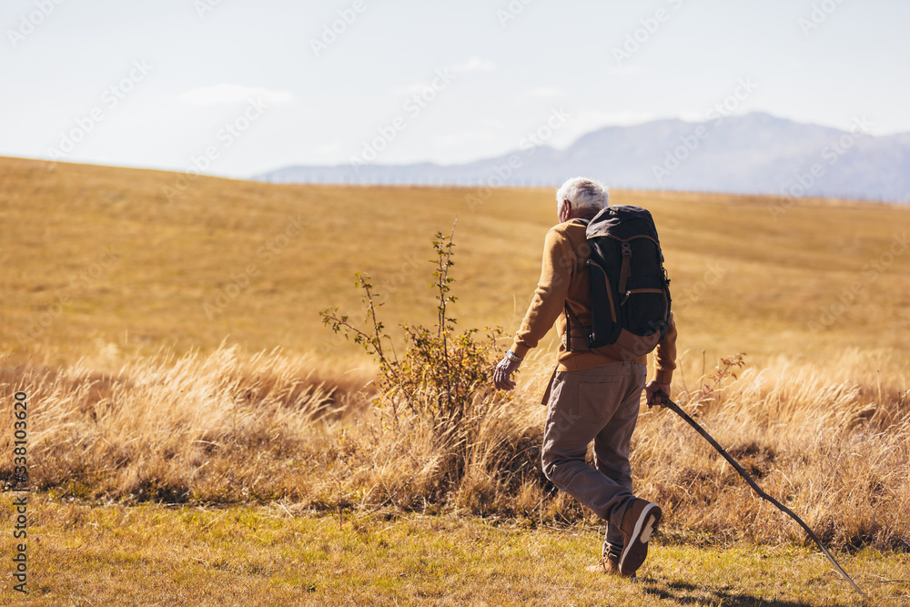 Senior man on hike through beautiful countryside in autumn. Senior man on hike through beautiful countryside in autumn.