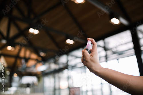 Spraying Anti-Bacterial Sanitizer Spray, Hand Sanitizer Dispenser, infection control concept. Sanitizer to prevent Coronavirus or Covid-19, flu. Spray bottle. 70% Alcohol spray. Hand spray.