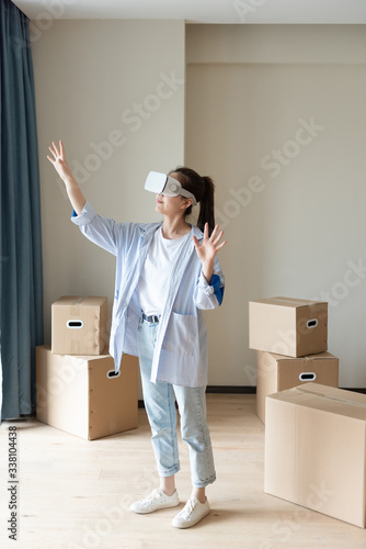 A young asian woman is using VR glasses