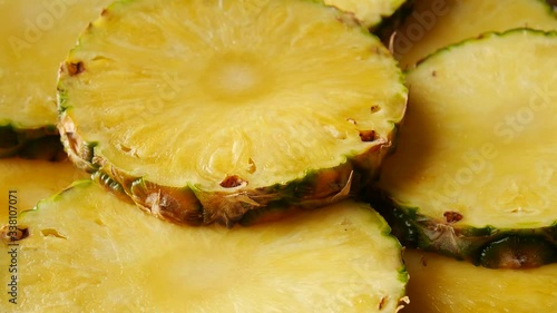 Cut pineapple on a plate.