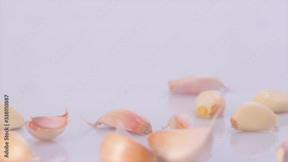 heads of garlic in moderation roll towards the camera heads of garlic in moderation roll towards the camera