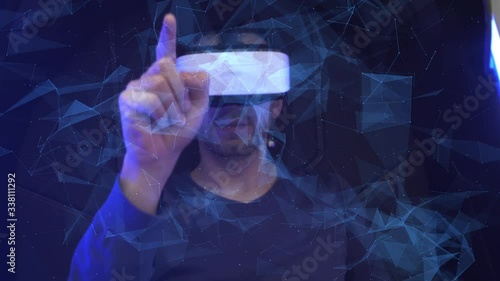 Model young man in glasses of virtual reality on dark background.. Augmented reality, science, future technology concept. VR. Futuristic 3d glasses with virtual projection. Neon light.