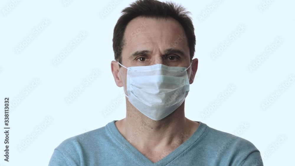 Man looks around, removes medical face mask. Coronavirus pandemic quarantine Man looks around, removes medical face mask. Coronavirus pandemic quarantine
