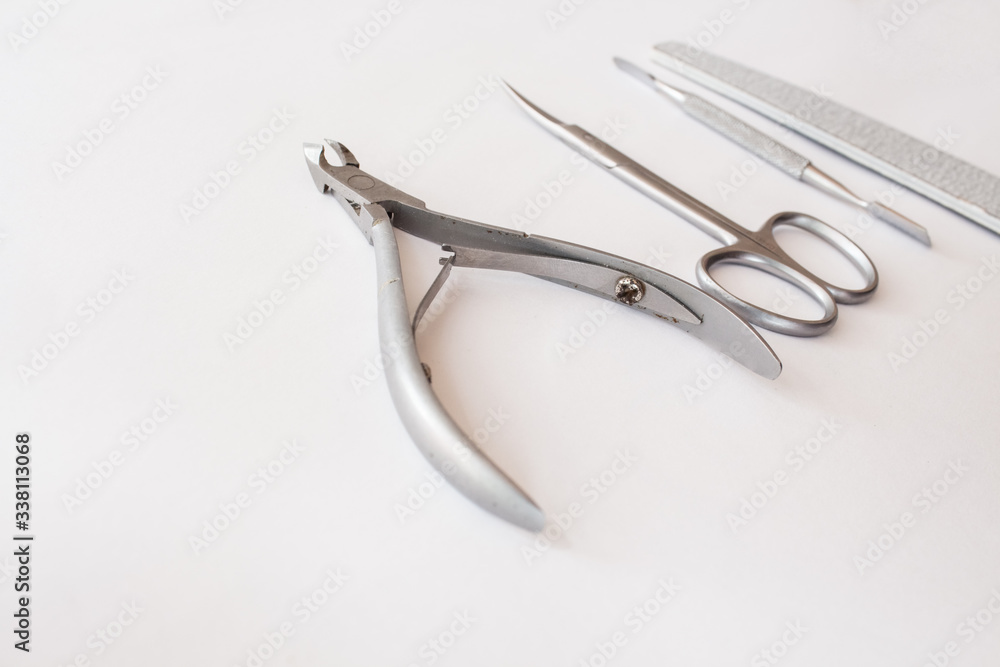 set of tools for manicure on a white background close-up. top view, text space. set of tools for manicure on a white background close-up. top view, text space.