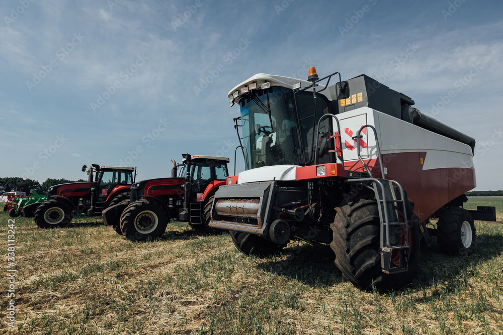 white red harvester on a sunny day in a field white red harvester on a sunny day in a field